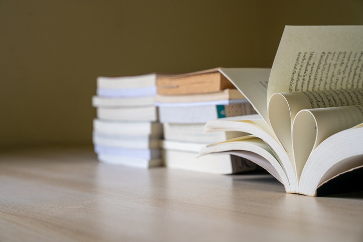 Open Book with Heart Shaped Pages on Wooden Desk in Soft Natural Light for Education, Reading, Literature, Knowledge, Academic Learning, Study Inspiration, and Love of Books 
